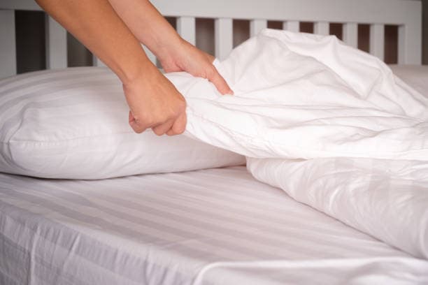 Fresh linen and towel change for a short-term rental bedroom